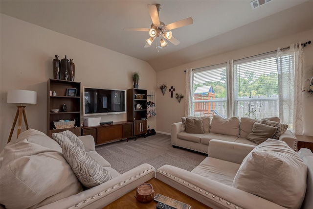 carpeted living area featuring a ceiling fan, baseboards, visible vents, and lofted ceiling