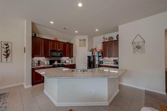kitchen featuring visible vents, tasteful backsplash, a sink, light tile patterned floors, and black appliances