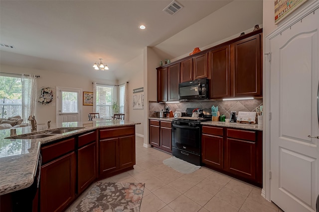 kitchen with a sink, decorative backsplash, light tile patterned floors, visible vents, and black appliances