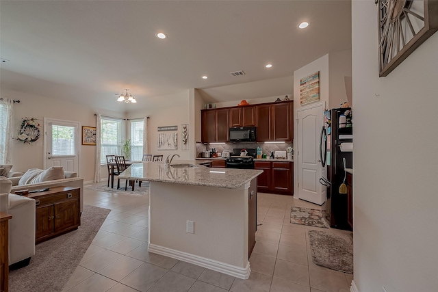 kitchen with light tile patterned flooring, a sink, recessed lighting, visible vents, and black appliances