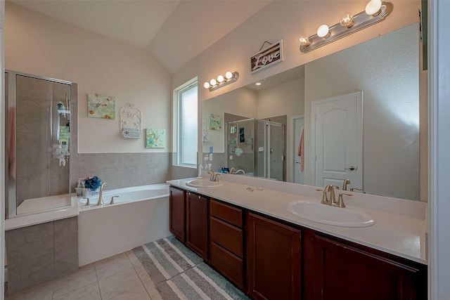 bathroom with tile patterned flooring, a sink, a garden tub, and a shower stall