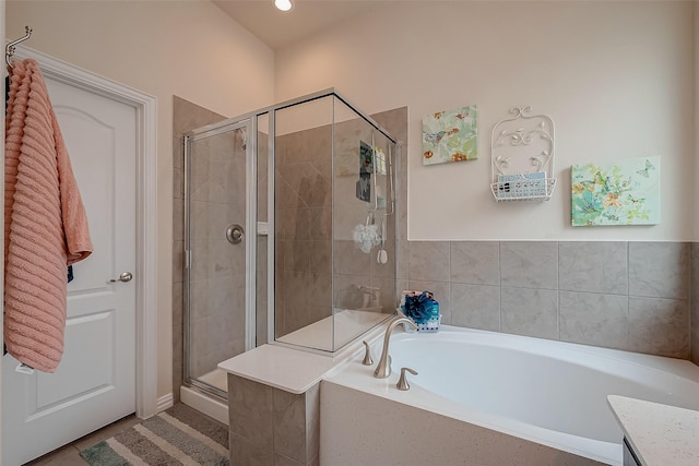 bathroom with recessed lighting, tile patterned flooring, a bath, and a stall shower