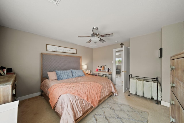bedroom with light colored carpet, baseboards, and ceiling fan