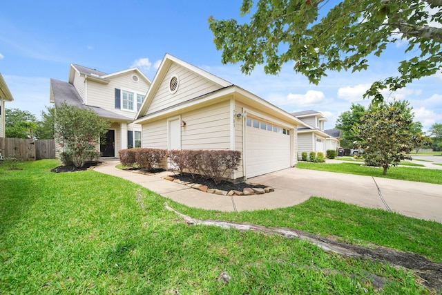 traditional home with a garage, a front lawn, fence, and driveway