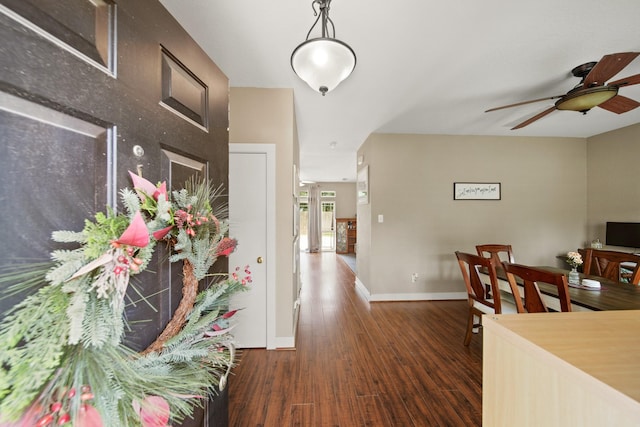 interior space featuring baseboards and wood finished floors
