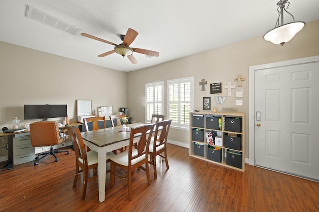 dining area featuring visible vents, a ceiling fan, baseboards, and wood finished floors