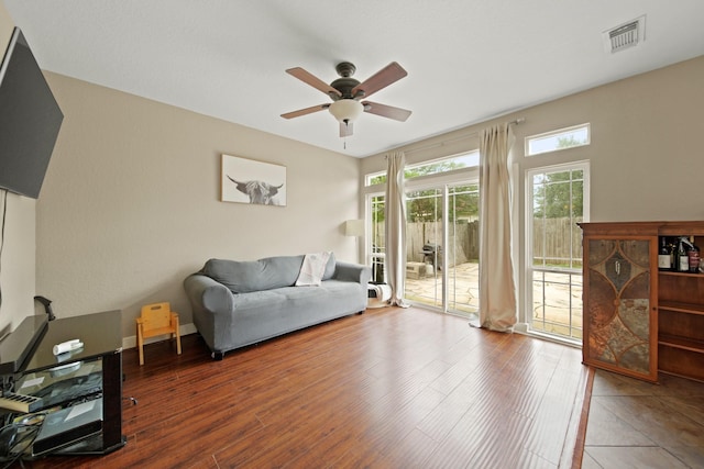 living room featuring ceiling fan, wood finished floors, and visible vents