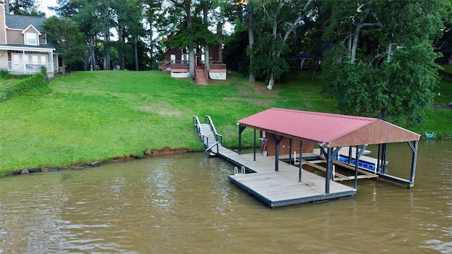 view of dock with a water view and a yard