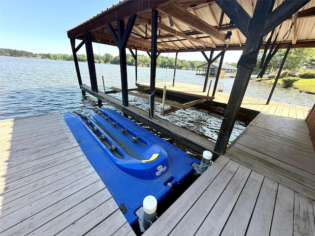 view of dock with boat lift and a water view