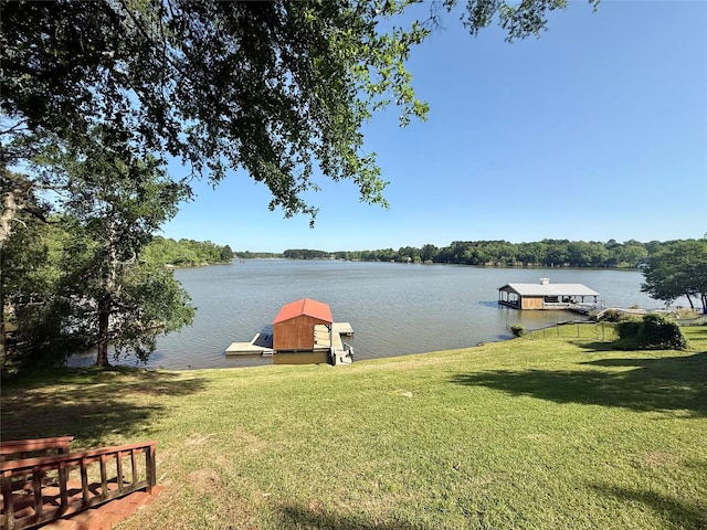 dock area featuring a water view and a yard