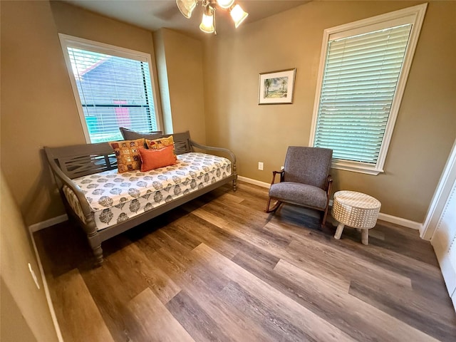 bedroom with baseboards and wood finished floors