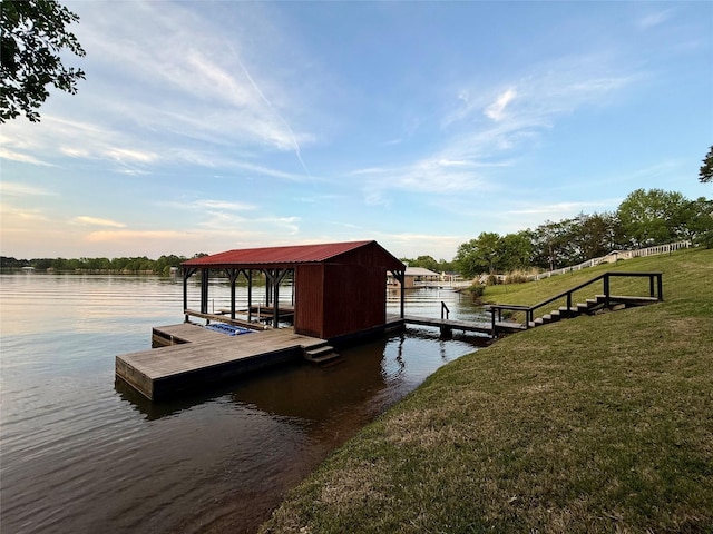 dock area featuring a yard, boat lift, and a water view