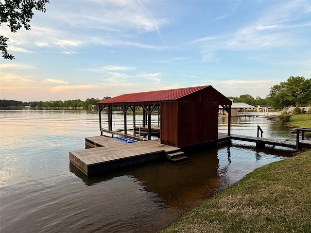 dock area with boat lift and a water view