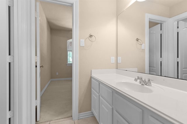 bathroom featuring baseboards and vanity
