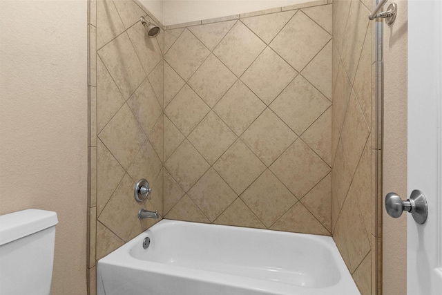 bathroom featuring toilet and  shower combination