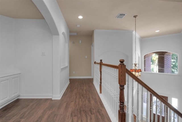 hall with visible vents, baseboards, dark wood-type flooring, recessed lighting, and arched walkways