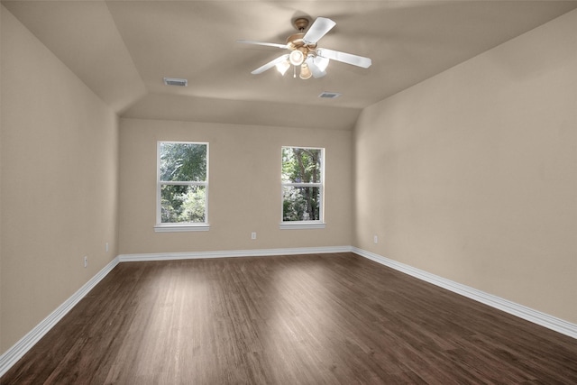 unfurnished room with baseboards, visible vents, and dark wood-style floors