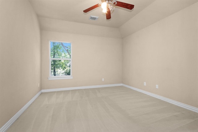 empty room with baseboards, ceiling fan, light carpet, and visible vents