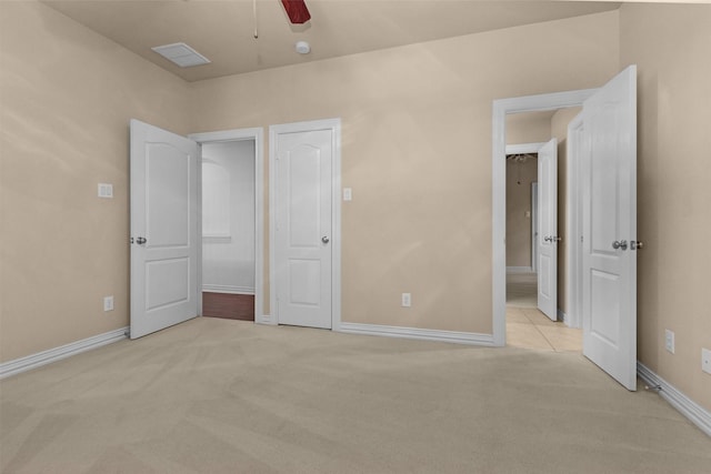 unfurnished bedroom featuring baseboards, ceiling fan, and light carpet