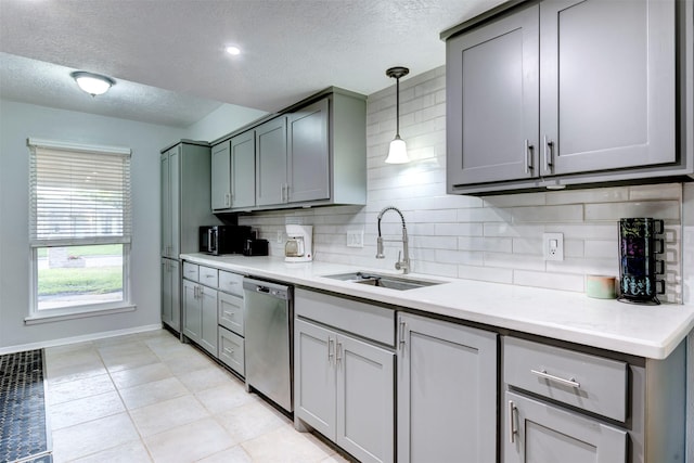 4114 Cicada Ln, Houston, TX 77039 - kitchen featuring a sink, a textured ceiling, gray cabinets, decorative backsplash, and stainless steel dishwasher