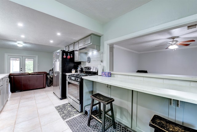 4114 Cicada Ln, Houston, TX 77039 - kitchen with a ceiling fan, a textured ceiling, visible vents, appliances with stainless steel finishes, and a breakfast bar