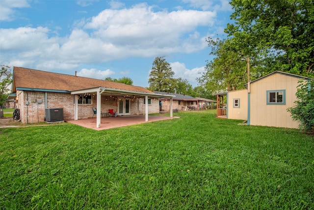4114 Cicada Ln, Houston, TX 77039 - back of property with a patio area, central air condition unit, brick siding, an outdoor structure, and a yard