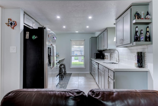 4114 Cicada Ln, Houston, TX 77039 - kitchen featuring open shelves, a sink, gray cabinets, stainless steel appliances, and light tile patterned floors
