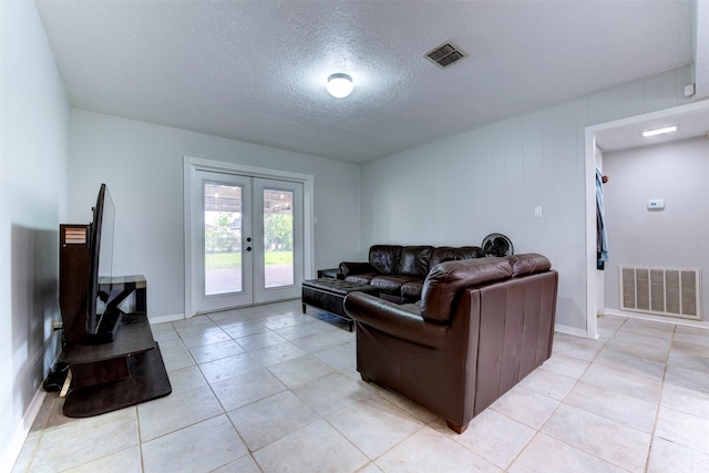 4114 Cicada Ln, Houston, TX 77039 - living room with light tile patterned floors, a textured ceiling, visible vents, and french doors