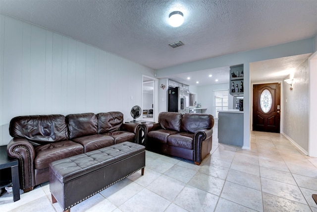 4114 Cicada Ln, Houston, TX 77039 - living area with visible vents, a textured ceiling, and light tile patterned floors