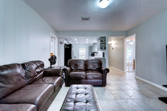 4114 Cicada Ln, Houston, TX 77039 - living room with visible vents, a textured ceiling, and baseboards