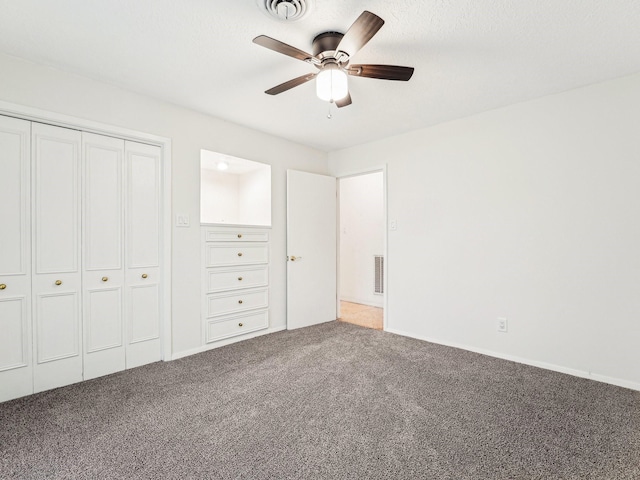 unfurnished bedroom with ceiling fan, a closet, visible vents, and carpet