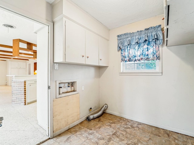 laundry room featuring cabinet space, washer hookup, gas dryer hookup, a textured ceiling, and visible vents