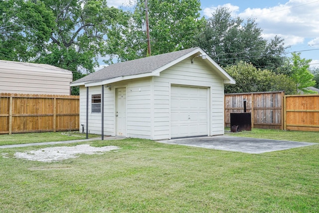 detached garage with driveway and fence