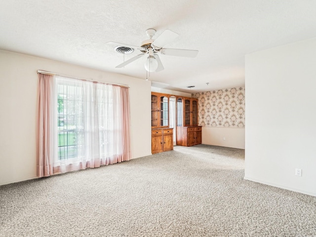 carpeted empty room with ceiling fan