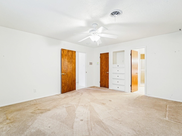 unfurnished bedroom with baseboards, ceiling fan, visible vents, and carpet floors