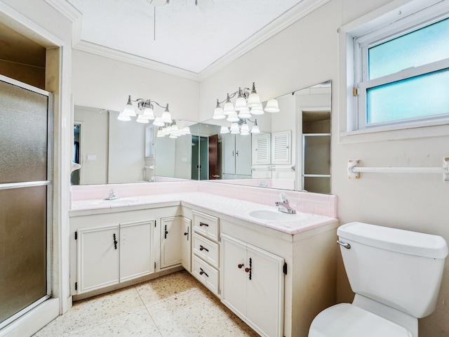 bathroom featuring toilet, a stall shower, ornamental molding, and a sink
