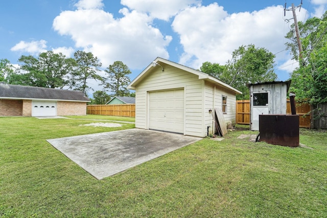 detached garage featuring fence