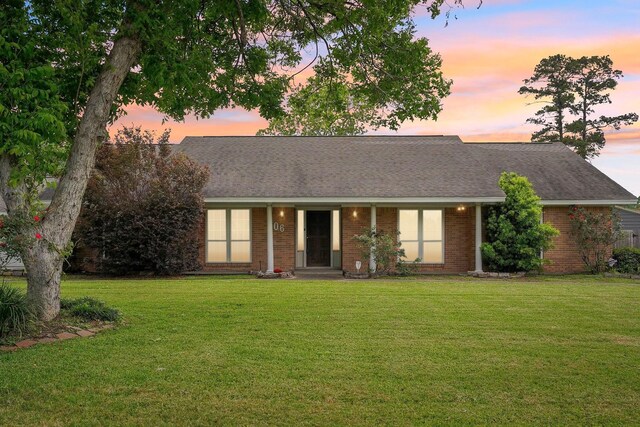 106 Faith St, Highlands, TX 77562 - view of front of property with a front yard and brick siding