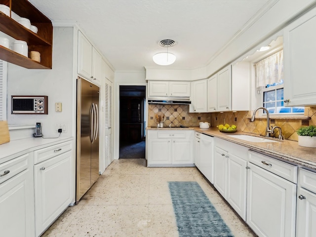 106 Faith St, Highlands, TX 77562 - kitchen with stainless steel refrigerator, a sink, ornamental molding, backsplash, and light countertops
