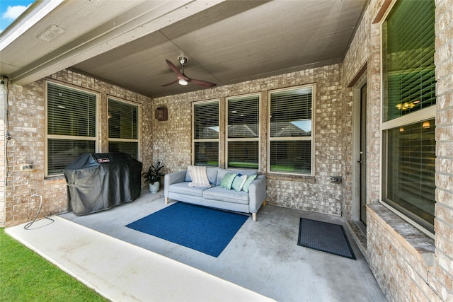 view of patio / terrace with a ceiling fan, area for grilling, and an outdoor living space