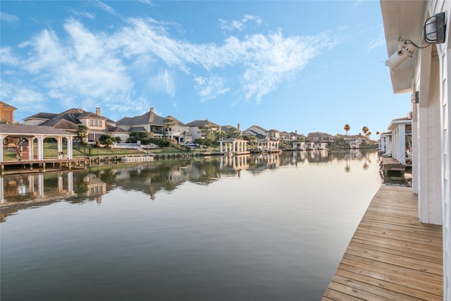 dock area with a water view and a residential view