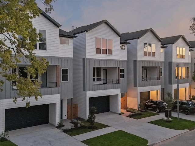 view of front facade featuring a garage, board and batten siding, and driveway