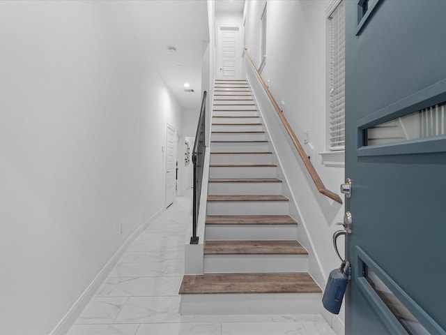 staircase with baseboards and marble finish floor
