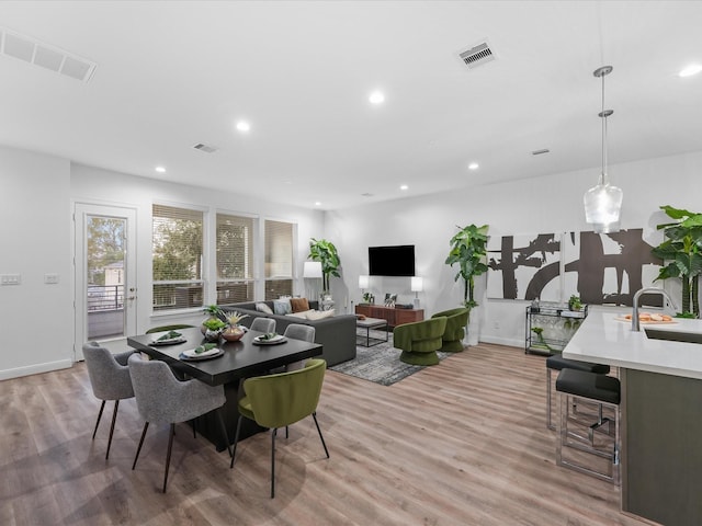 dining space with recessed lighting, visible vents, and light wood-style floors