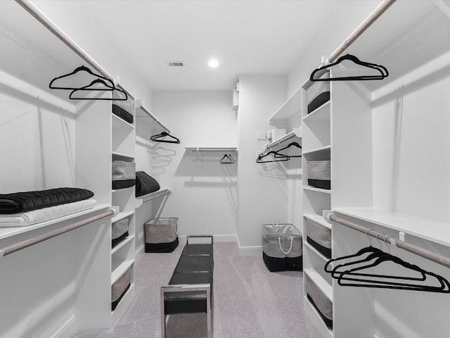 walk in closet featuring visible vents and carpet flooring