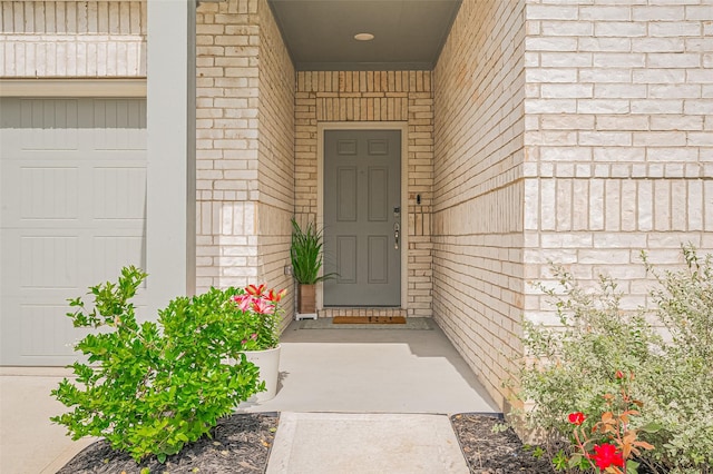 view of exterior entry with brick siding