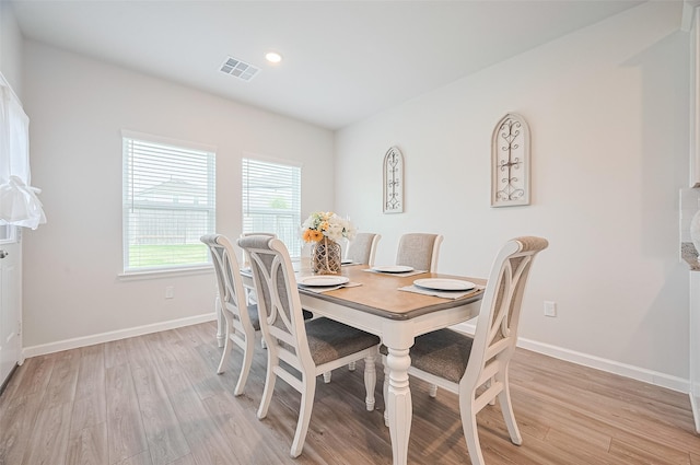dining area featuring light wood-style floors, visible vents, baseboards, and recessed lighting