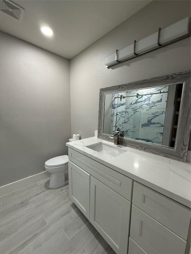 175 Heather Ln, Livingston, TX 77351 - bathroom with vanity, toilet, a marble finish shower, and visible vents