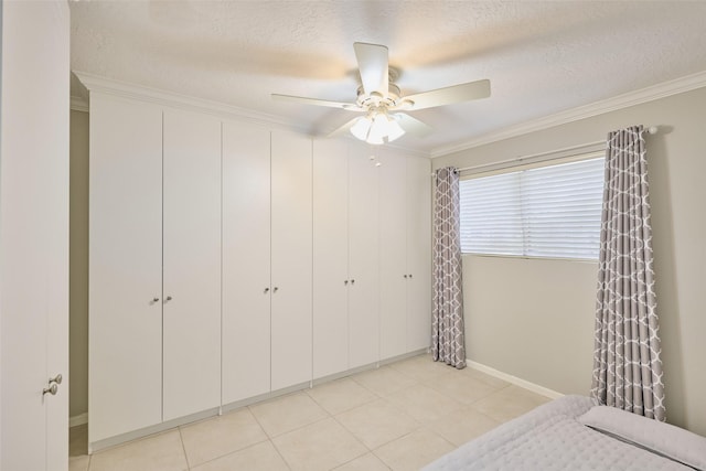 801 River Rd Unit 105D, Montgomery, TX 77356 - bedroom featuring a textured ceiling, ornamental molding, and a closet