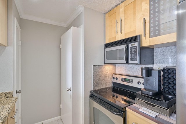 801 River Rd Unit 105D, Montgomery, TX 77356 - kitchen with light brown cabinetry, crown molding, black microwave, stainless steel range with electric stovetop, and backsplash